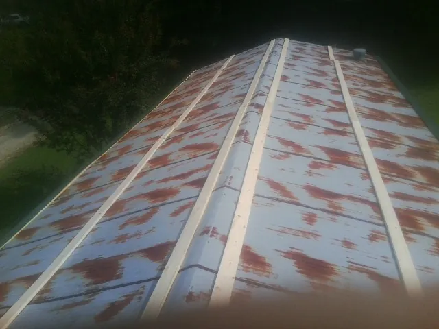 Rusted metal roof panels with new wood purlins before replacement — Storm Damage Roof Repair in Sagamore by Roofing Brothers